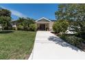 Charming home with a well-manicured lawn and decorative front door at 4055 Floramar Ter, New Port Richey, FL 34652