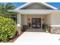 Inviting front porch with decorative columns and double entry doors at 4055 Floramar Ter, New Port Richey, FL 34652