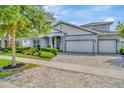 Charming one-story home with a well manicured lawn, three car garage and stone accents at 4093 Epic Cv, Land O Lakes, FL 34638