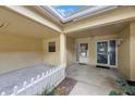 The entryway features a small fence and glass doors creating an inviting atmosphere at 413 Somerset Ln, Palm Harbor, FL 34684