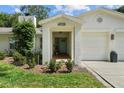 Inviting front entrance with a covered porch, light blue door, and manicured landscaping at 4705 W Estrella St, Tampa, FL 33629