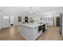 Bright kitchen featuring a large island, modern appliances, and a seamless flow to living spaces at 4705 W Estrella St, Tampa, FL 33629