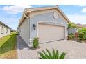 Charming home featuring paver driveway, beige garage door, well-kept lawn, and professional landscaping at 4914 Sienna Isles Ave, Wimauma, FL 33598
