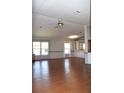 Open living room with hardwood floors, neutral paint and a ceiling fan at 5714 Cheyenne St, Zephyrhills, FL 33542