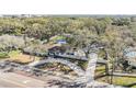 A beautiful home boasts mature trees and a circular driveway in an aerial view at 5744 150Th N Ave, Clearwater, FL 33760