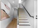 Bright stairway features modern design with light wood floors and black handrail at 607 W Euclid Ave # 3, Tampa, FL 33602