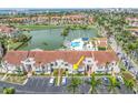 A view of the condo's facade, showing the entrance, parking, and landscaping at 6100 Bahia Del Mar Cir # 105, St Petersburg, FL 33715