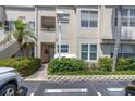 A closer view of the condo's facade, showing the entrance and landscaping at 6100 Bahia Del Mar Cir # 105, St Petersburg, FL 33715