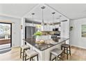 Modern kitchen featuring a center island with seating, stainless steel appliances, and ample cabinet space at 6190 80Th N St # 102, St Petersburg, FL 33709