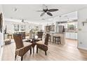 Bright living room featuring a ceiling fan, open-concept layout, and smooth flooring for a warm ambiance at 6190 80Th N St # 102, St Petersburg, FL 33709