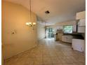 Eat-in kitchen with tile floors, white cabinetry, and sliding glass door to the backyard at 650 Palm Pl, Safety Harbor, FL 34695
