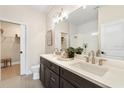 Bathroom featuring double sinks, quartz countertops, and a glass-enclosed shower at 7798 93Rd N St # 1, Seminole, FL 33777