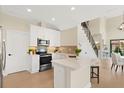 Modern kitchen boasts stainless steel appliances, sleek white cabinetry, and a breakfast bar at 7798 93Rd N St # 1, Seminole, FL 33777