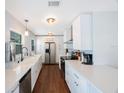 Bright kitchen with white cabinets, stainless steel appliances, and modern countertops at 9043 108Th Ave, Seminole, FL 33777