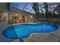 Sparkling pool with screened lanai, ample seating and lush landscaping for ultimate relaxation at 9208 Brindlewood Dr, Odessa, FL 33556