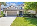 Beautiful two-story home featuring a two-car garage and a well-maintained lawn at 9317 Bella Vita Cir, Land O Lakes, FL 34637