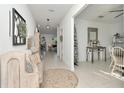 Inviting hallway with neutral decor, tiled floor, decorative accents, and an open concept design at 9734 Branching Ship Trce, Wesley Chapel, FL 33545