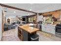 Open kitchen featuring butcher block island and stainless steel appliances at 9821 113Th St # 201, Seminole, FL 33772