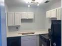 Bright kitchen with white cabinetry, countertops, and modern lighting at 1221 E Hamilton Ave, Tampa, FL 33604