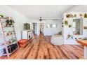 Bright living room featuring hardwood floors, lots of decor and plants with natural light creating a serene atmosphere at 1221 E Hamilton Ave, Tampa, FL 33604