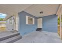 Covered front porch with a tiled entryway, features the main door, and an additional entry point at 1304 N Ferrell St, Plant City, FL 33563