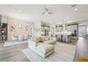 Open-concept living space with a comfortable sofa, a dining area, and a view of the modern kitchen at 13098 Wellspring Dr, Lithia, FL 33547