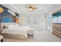Serene main bedroom with elegant decor, tray ceilings, and a door to the screened patio at 13098 Wellspring Dr, Lithia, FL 33547