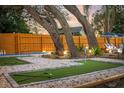 Entertain in the beautiful backyard with a custom putt putt course and lush landscaping at 1394 Stonehenge Way, Palm Harbor, FL 34683