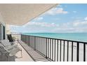 Balcony with seating, overlooking the white sand beach and beautiful ocean at 14300 Gulf Blvd # 401, Madeira Beach, FL 33708