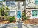 Charming condo featuring a well-maintained front exterior with neat landscaping and a freshly painted door at 14611 Pine Glen Cir, Lutz, FL 33559