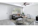 Inviting living room with modern furniture, a cozy rug, and a large window offering ample natural light at 14611 Pine Glen Cir, Lutz, FL 33559