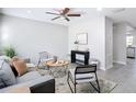 Bright living room featuring a ceiling fan, contemporary furnishings, and neutral decor at 14611 Pine Glen Cir, Lutz, FL 33559