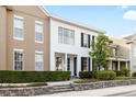 Inviting townhome showcasing classic design, complemented by lush greenery and a neatly landscaped yard at 14648 Bournemouth Rd, Tampa, FL 33626
