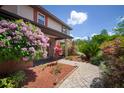 Inviting front yard showcasing a brick walkway, colorful flowers, and lush landscaping at 18712 Lakeshore Dr, Lutz, FL 33549