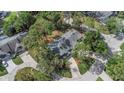 An aerial view of the house shows the roof line, mature trees, and surrounding neighborhood streets at 200 Pinewinds Blvd, Oldsmar, FL 34677