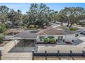 Aerial view of a white single-story home with a covered carport and manicured landscaping at 202 W Azalea Ave, Tampa, FL 33612