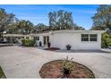 Exterior of a well-maintained single-story home with a spacious driveway and tidy landscaping at 202 W Azalea Ave, Tampa, FL 33612
