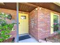 Inviting entryway with red brick, decorative door accents, and manicured landscaping at 2524 Laurelwood Ln, Valrico, FL 33596
