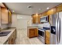 A well-equipped kitchen featuring stainless steel appliances, granite countertops, and wooden cabinets at 2608 Browning St, Sarasota, FL 34237