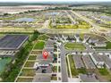 Aerial view showcasing the neighborhood and community amenities including ponds and green spaces at 2858 Star Anise Ln, Wimauma, FL 33598