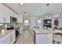 Modern kitchen featuring white cabinets, stainless steel appliances, and granite countertops at 2858 Star Anise Ln, Wimauma, FL 33598