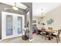 Elegant foyer with a view of the dining area, featuring tile floors and chandelier at 311 Parsons Woods Dr, Seffner, FL 33584