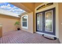 Inviting front porch featuring decorative double doors and brick flooring at 311 Parsons Woods Dr, Seffner, FL 33584