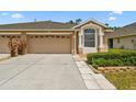 Charming single-story home featuring an attached two-car garage and well-maintained landscaping at 31105 Whitlock Dr, Wesley Chapel, FL 33543