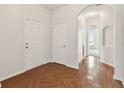 Bright foyer featuring wood floors, white walls, and an arched entryway at 31105 Whitlock Dr, Wesley Chapel, FL 33543