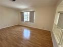 Bright living room with hardwood floors, a large window, and neutral walls at 3276 38Th S Way # D, St Petersburg, FL 33711