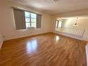 Spacious living room with hardwood floors, large window and ample natural light at 3276 38Th S Way # D, St Petersburg, FL 33711