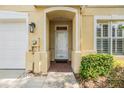 Welcoming front entrance featuring a brick walkway, covered entryway, and stylish exterior lighting at 3429 Heards Ferry Dr, Tampa, FL 33618