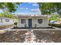 Inviting home featuring a tidy front yard with decorative stones and vibrant landscaping, highlighting its charm at 3838 29Th N St, St Petersburg, FL 33714