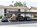 Exterior view of parking spots in front of well-maintained condos and landscaped surroundings at 3861 Sailmaker Ln # 3861, Holiday, FL 34691